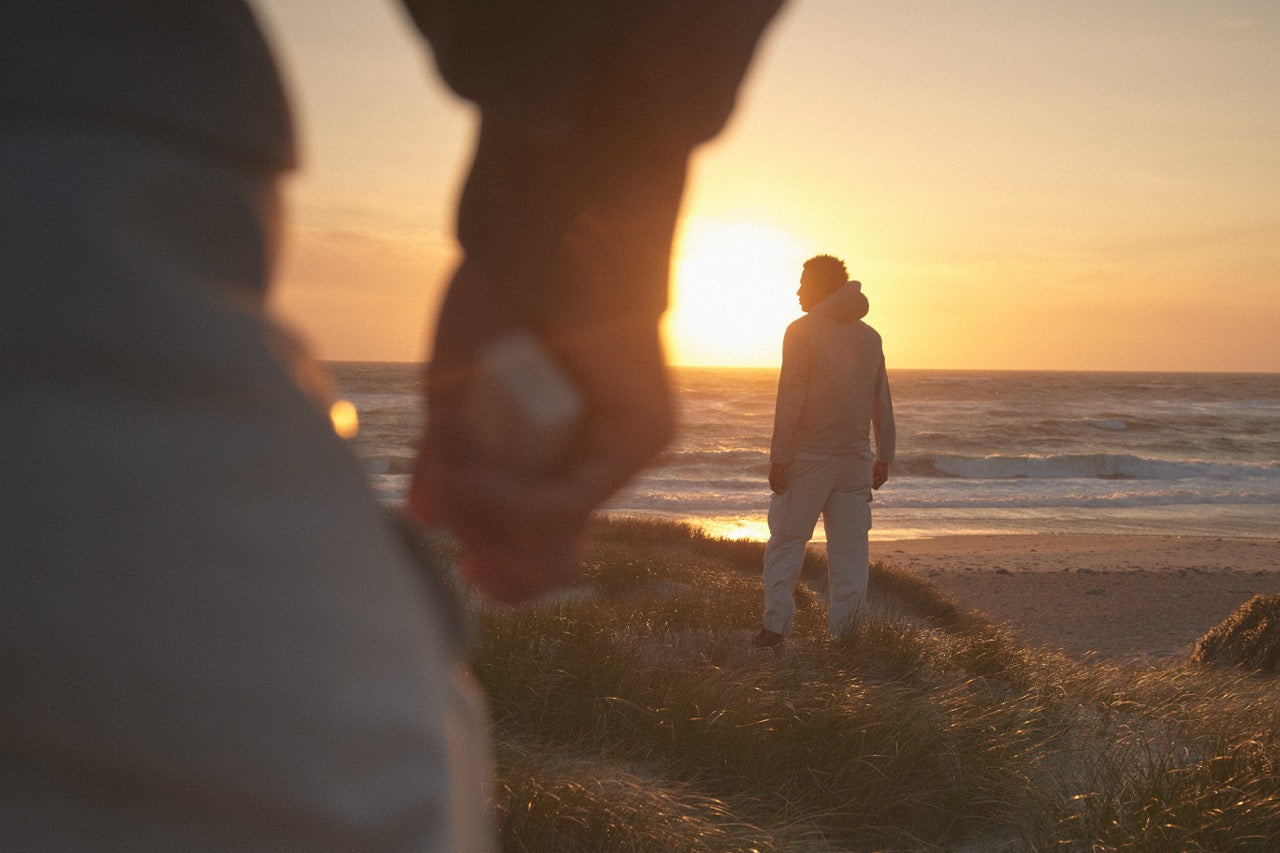 A hopeful sunrise: one looks ahead, while another grips a pack of NOAT.